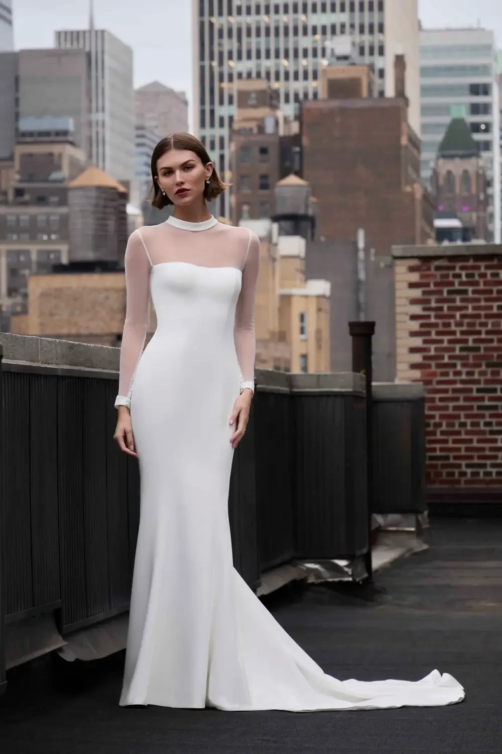 model is wearing a long sleeve bridal gown with an optional skirt