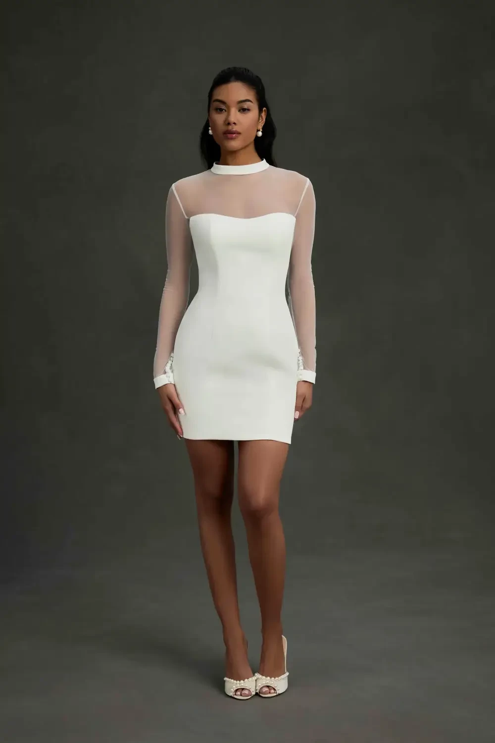 model is wearing a long sleeve bridal gown with an optional skirt